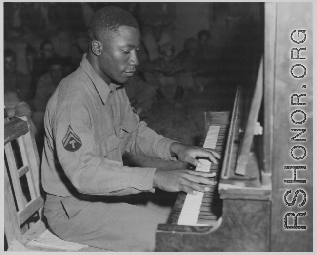 African-American musician playing piano for other GIs in the CBI during WWII.
