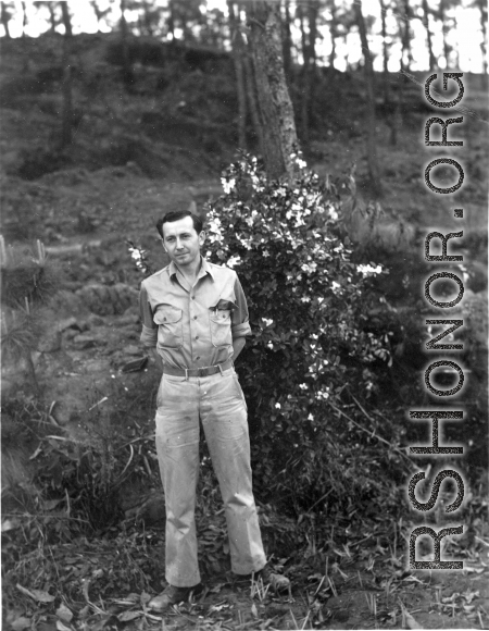 Eugene Wozniak poses among pines at Yangkai air base during WWII.