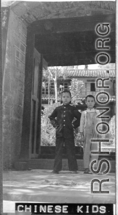 Local boys stand in the entry to a courtyard at Chanyi (Zhanyi) during WWII.
