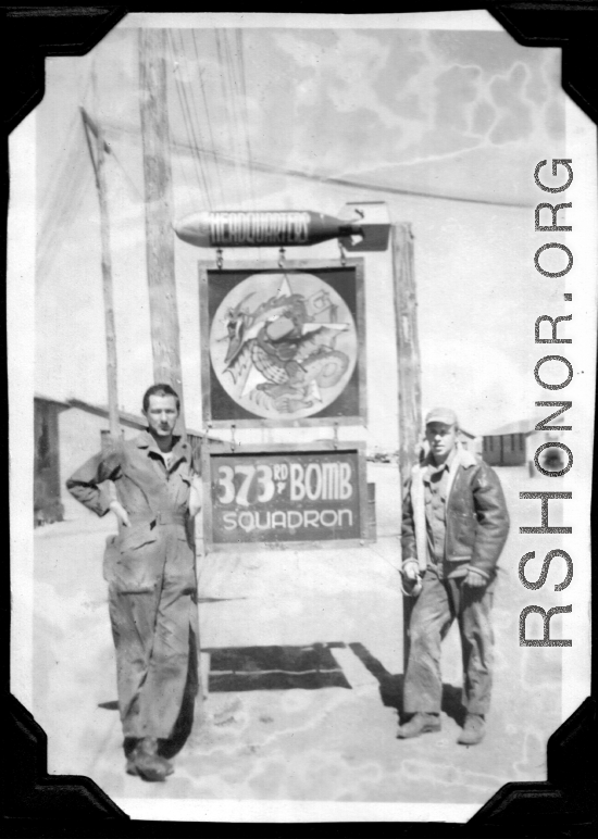 Mechanics pose with 373rd Bombardment Squadron HQ sign, presumably at Luliang air base, Yunnan, China. During WWII.