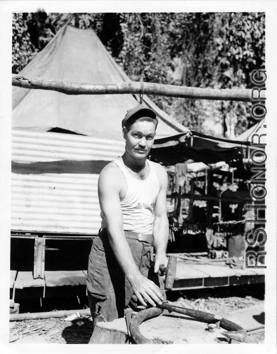 Engineer of the 797th Engineer Forestry Company in Burma, repairing skidding tongs.  During WWII.