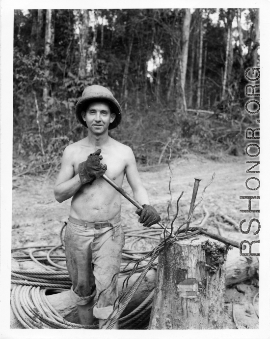 Engineer of the 797th Engineer Forestry Company in Burma, weaving a pulling eye in cable.  During WWII.