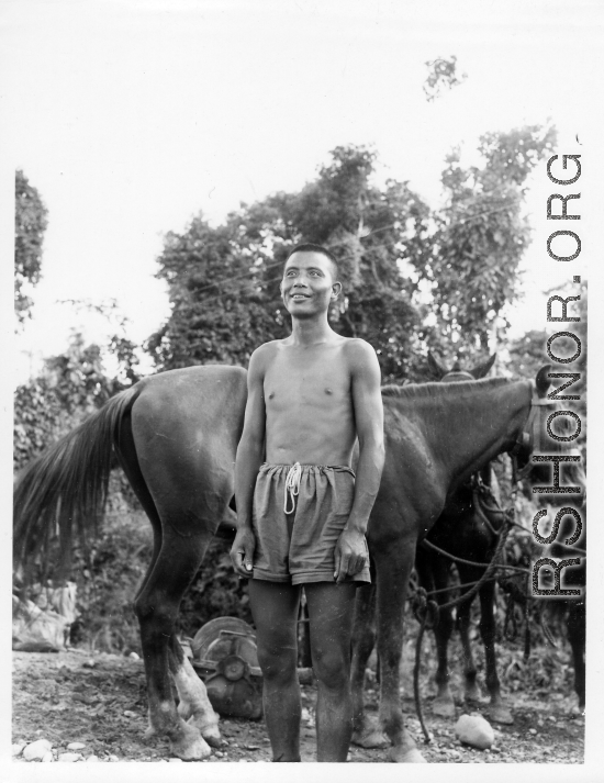 Local people in Burma near the 797th Engineer Forestry Company--A man poses with horse.  During WWII.