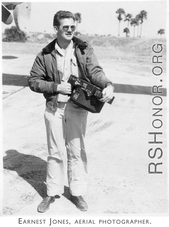 Aerial Photographer Earnest Jones, holding camera.