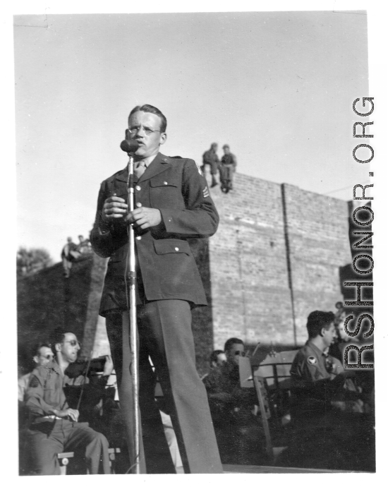 Enlisted man sings at a USO show in Gushkara, India, during WWII.