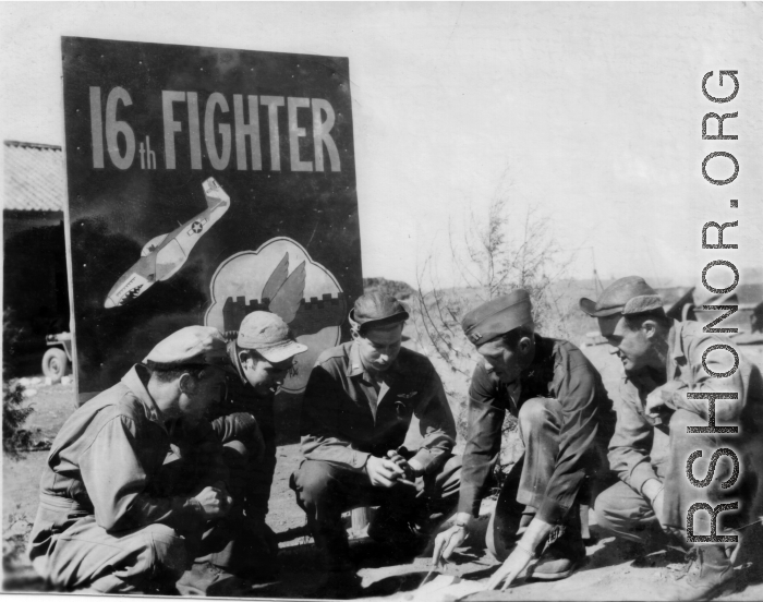 American flyers of the 16th Fighter Squadron in China, before a sign at Chenggong. Stanley Mamlock in center of group.  In Chinese the sign says "Great Wall In The Air" ("空中長城").  During WWII.