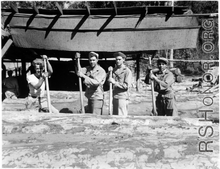 Wranging logs towards saw with cant hooks at a lumber mill of the 797th Engineer Forestry Company in Burma.  During WWII.