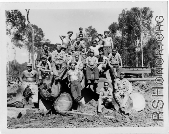 Engineers of the 797th Engineer Forestry Company pose on logs in Burma.  During WWII.