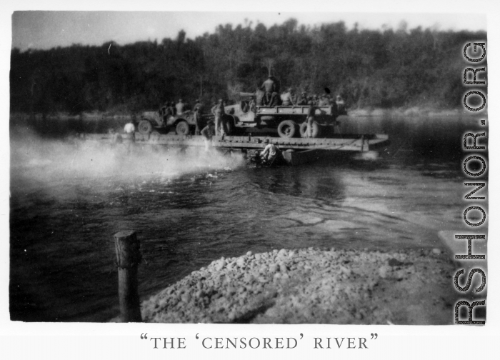 Trucks on ferry on river in Burma.  During WWII.  797th Engineer Forestry Company.