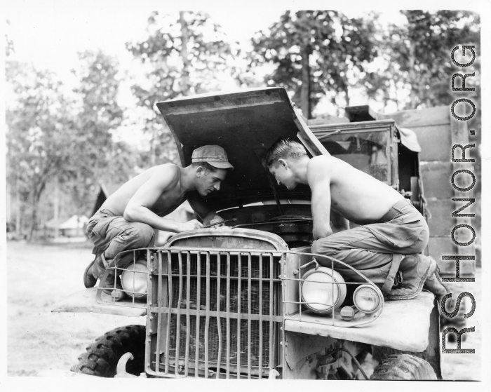 Engineers of the 797th Engineer Forestry Company at work on a truck in Burma.  During WWII.