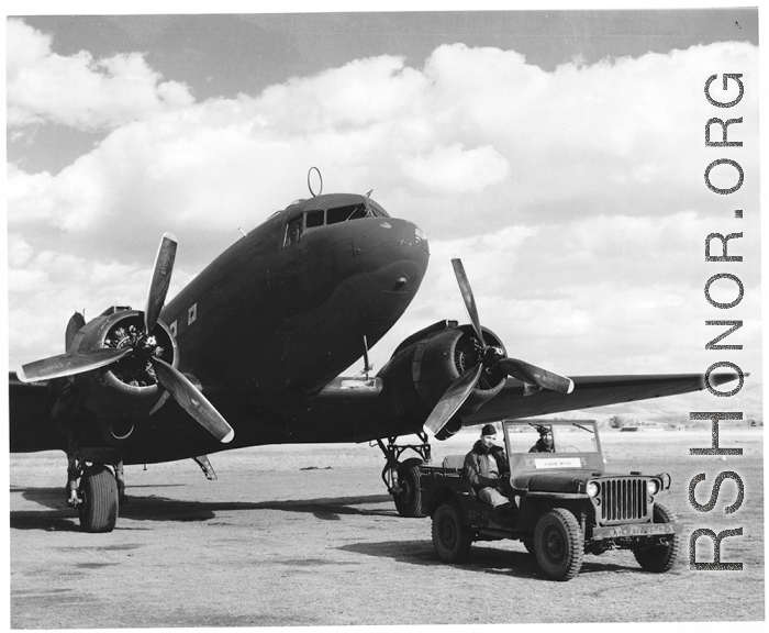 GIs in jeep wait before C-47 transport in China, during WWII. The jeep has a white placard saying "Airdrome Officer."   Although ICD-ATC is stenciled on the jeep, indicating Dum Dum Air Base, the terrain in the background is definitely not that of Dum Dum, and should be China. 