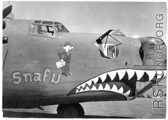 B-24 "Snafu," in CBI during WWII. The GI figure is holding a paper labeled "T. S. Ticket."