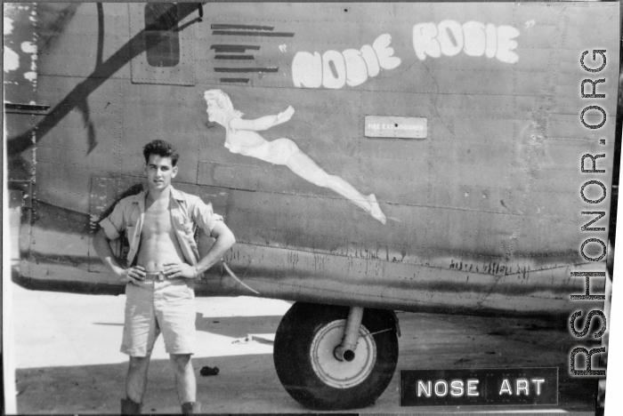 Flyer standing with B-24/F-7 "Nosie Rosie." 24th Combat Mapping Squadron, 8th Photo Reconnaissance Group, 10th Air Force