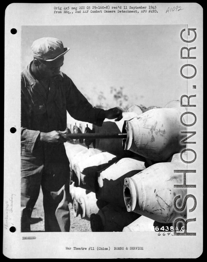 African-American serviceman putting the M-14 in the igniter of a M-76 500-pound incendiary bomb in China during WWII.