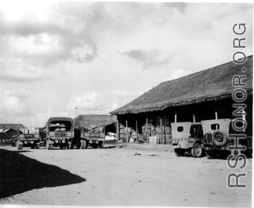 Parked jeeps and transport vehicles, Burma or SW China.