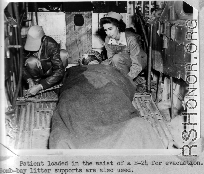 Patient loaded in the waist of a B-24 for evacuation.  Bomb-bay litter support are also used.