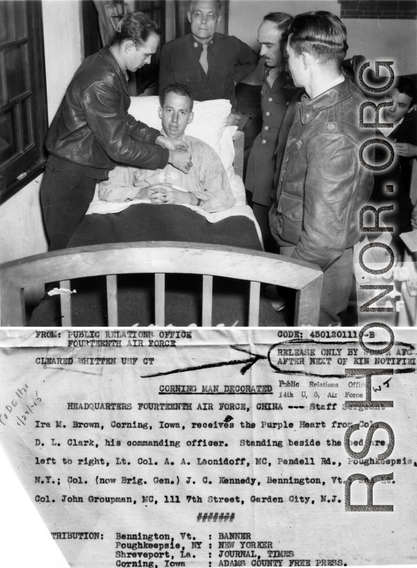 S/Sgt. Ira M. Brown, Corning, Iowa, receives Purple Heart from Col. D. L. Clark, Standing bedside are Lt. Col. A. A. Leonidoff, Col. J. C. Kennedy, and Lt. Col. John Groupman.  According to report in his hometown paper, The Adams County Free Press (Iowa), on March 15, 1945, S/Sgt. Brown had been wounded in battle, and had been a gunner 0n a B-25 stationed near Kunming, China.  He had graduated in 1938 from the Corning High School, Adams County, Iowa.