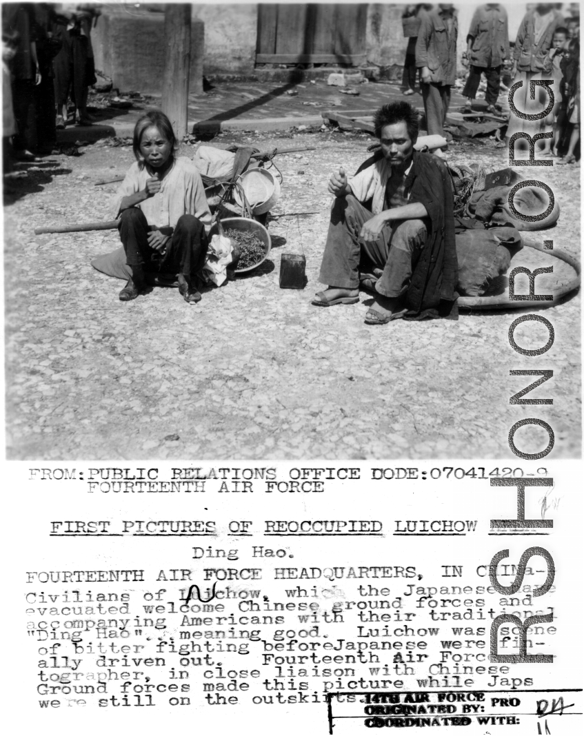 Two local civilians sit on the ground in destroyed Liuzhou after the return of Chinese and American forces on the tails of the Japanese retreat. In WWII.