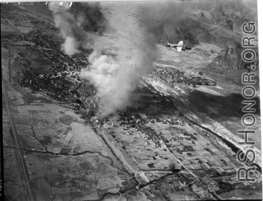 B-25s fly in front of Yishan (now Yizhou) in Guangxi province, SW China, among Karst peaks during the Japanese Ichigo campaign of summer and fall 1944. Towns along the Ichigo route were bombed by American planes as the Japanese moved into them, or sometimes in advance, to deny the resources of the towns to the incoming Japanese. The Japanese entered Yishan town on November 14, 1944, which should be the approximate date of this image. The Japanese stayed in Yishan until mid-June 1945, and allies bombed Yisha