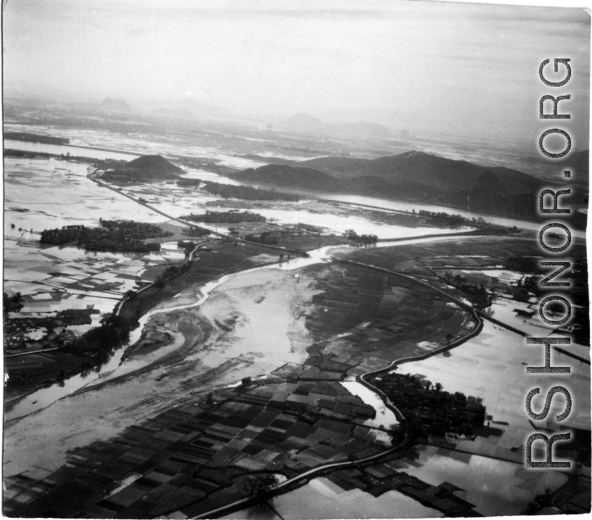 An aerial photograph during battle in the CBI. Note destroyed bridge in center of image.   (Images provided via Tony Strotman)
