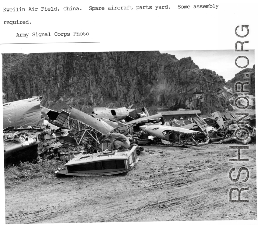 Engineers scavenge parts at Guilin (Kweilin) Air Field in a boneyard of parts of American military aircraft during WWII.  Army Signal Corps photo.