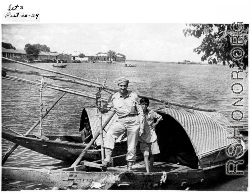 A GI in a boat with a young boat (who seems to be smoking) in Burma (or India) during WWII.  Image provided by Emery and Beth Vrana.