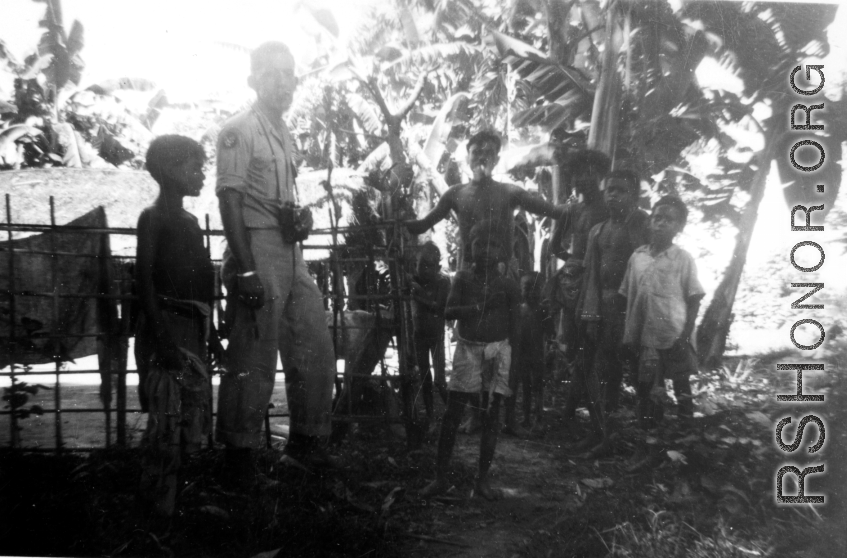 A camera-toting GI with local people in Misamari, India.  Local images provided to Ex-CBI Roundup by "P. Noel" showing local people and scenes around Misamari, India.    In the CBI during WWII. 
