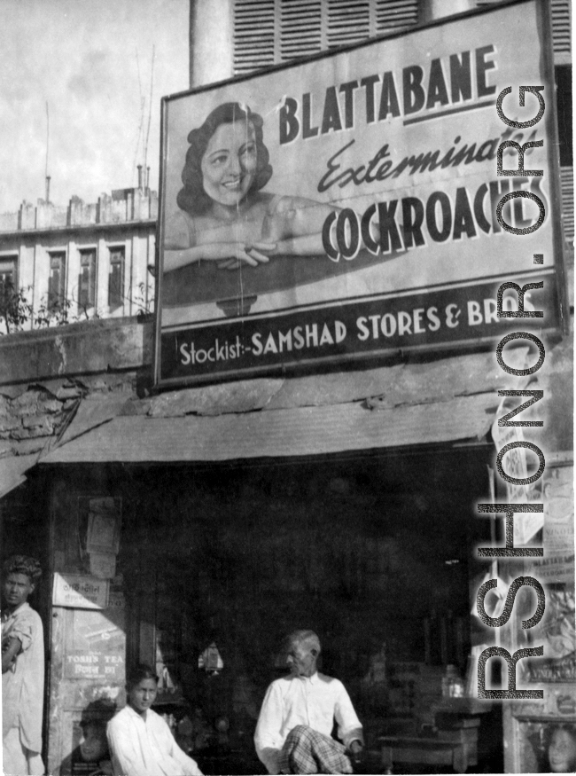 A shop with a large pesticide sign in India or Burma, during WWII.  In the CBI.