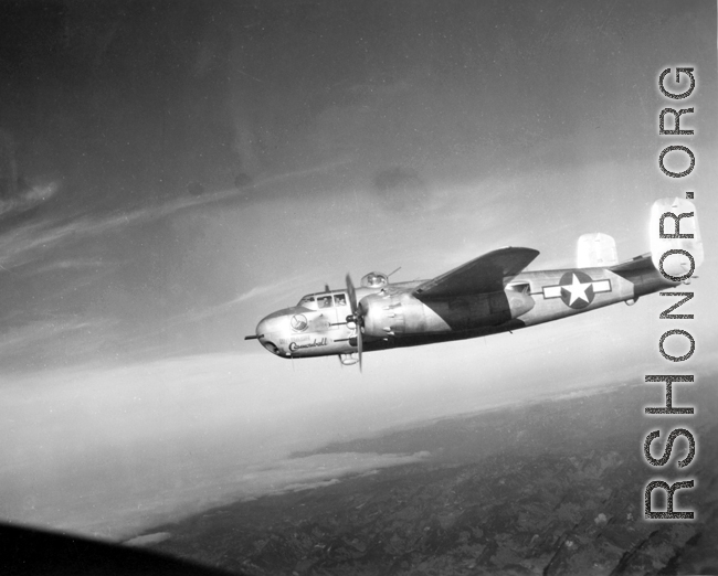 B-25H, "Wabash Cannonball", of the 491st Bomb Squadron in flight over China. Notice the 'smudge' behind the squadron emblem and below the pilot's side window. The smudge is the residue of the powder from when the side-mounted .50 caliber machine guns, are fired during a low-level attack on trains, rail yards, bridges, convoys, barges, troops, etc.  From the collection of Wozniak, combat photographer for the 491st Bomb Squadron, in the CBI.