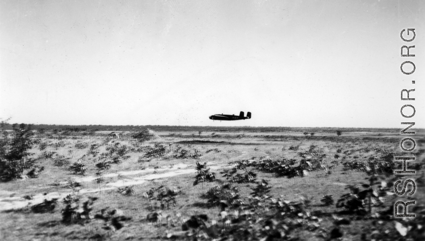 An American B-25D bomber flies at minimum altitude, probably during training / practice of 'low-level attack techniques.' Note the triangular peak just in front of the aircraft. This is probably piled up dirt and sand bags, used as the 'target' to learn and practice, especially for 'skip bombing'.   B-25 pilots of the Tenth Air Force (341st Bomb Group) and Chinese-American Composite Wing (1st Bomb Group) were trained in 'skip bombing' in India during 1943 and 1944.