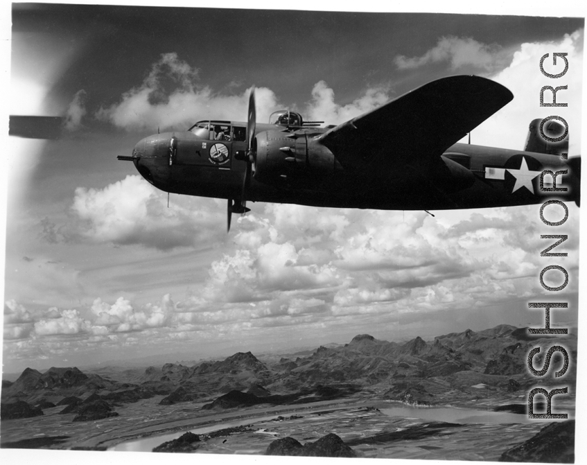 An unidentified B-25H of 491st Bm Sq in formation flight somewhere over karst formations in SW China. Photo was taken from the right, waist gun position of an aircraft.