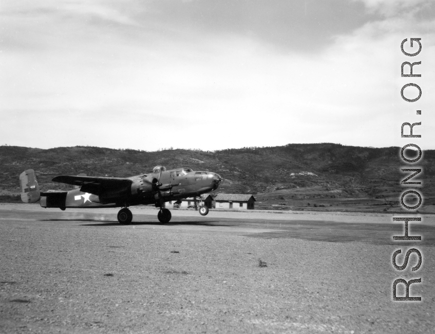 B-25 tail number 435 above a runway in Yunnan, likely Yangkai.  From the collection of Wozniak, combat photographer for the 491st Bomb Squadron, in the CBI.