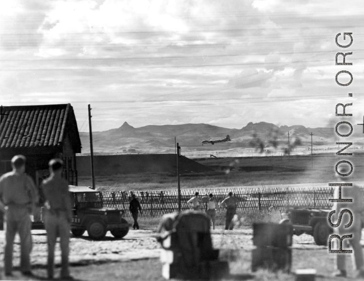 Everything stops as a Boeing B-29 Superfortress eases down to a runway in the CBI, probably at a base in Yunnan province. During WWII.