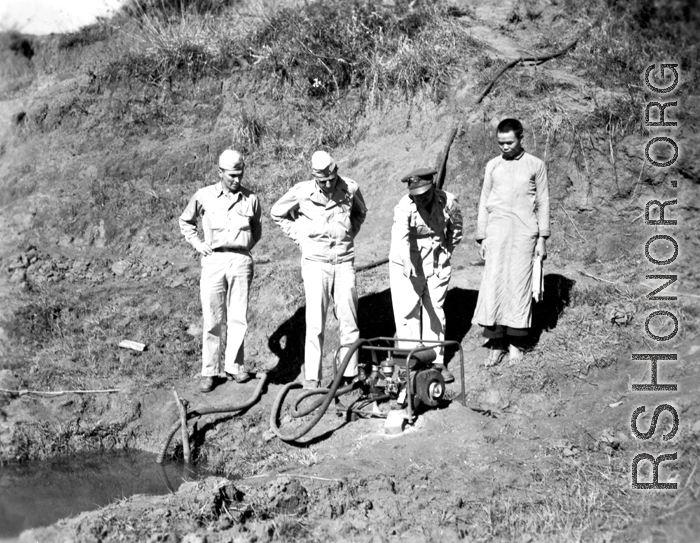 Base personnel inspect a water pump near an American base in Yunnan Province, China, during WWII.