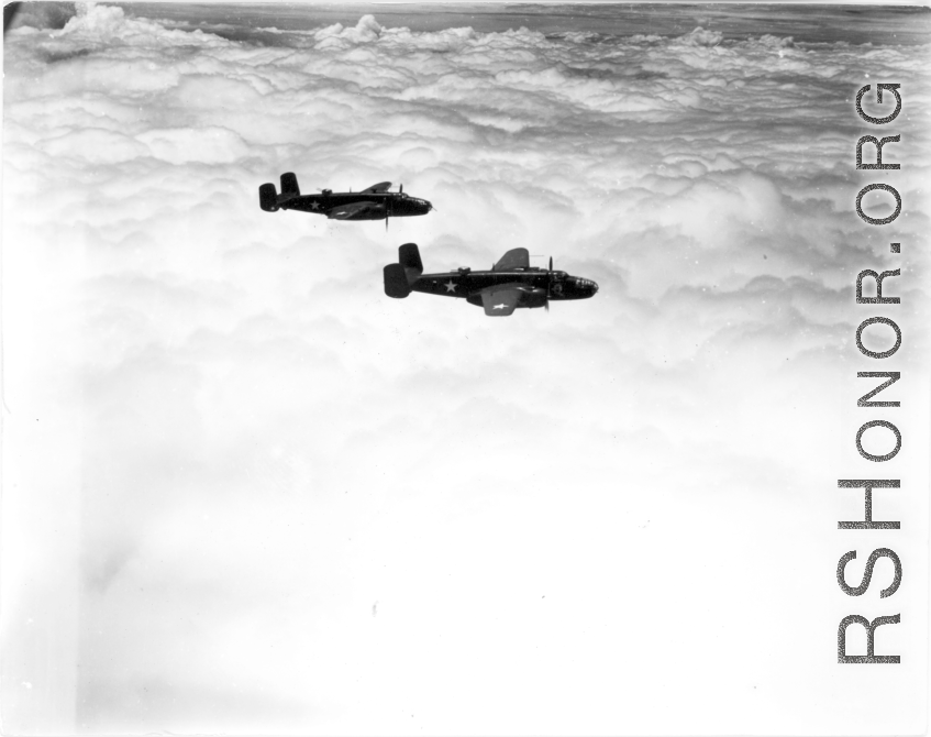Two B-25Ds of the 491st Bm Sq fly above a solid cloud layer.  Running out of fuel because clouds hid the air fields caused more aircraft losses in China than did the enemy aircraft or anti-aircraft fire.