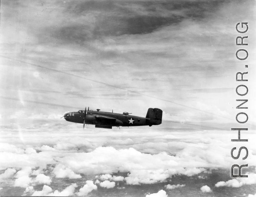 This unidentified B-25C has its bomb bay doors open as the formation approaches a target somewhere in Burma.  From the collection of Wozniak, combat photographer for the 491st Bomb Squadron, in the CBI.