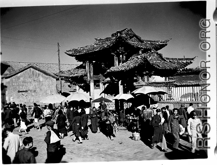 Local people in Yunnan province, China: A busy gate and market area. During WWII.