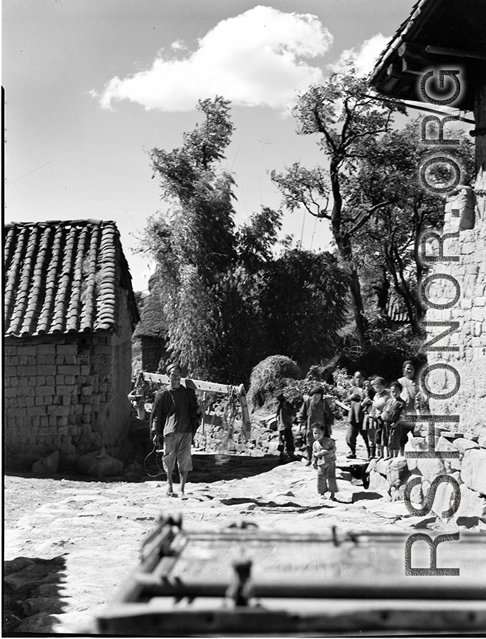 Local people in China: People on a path in a village in Yunnan, China, during WWII.  From the collection of Eugene T. Wozniak.
