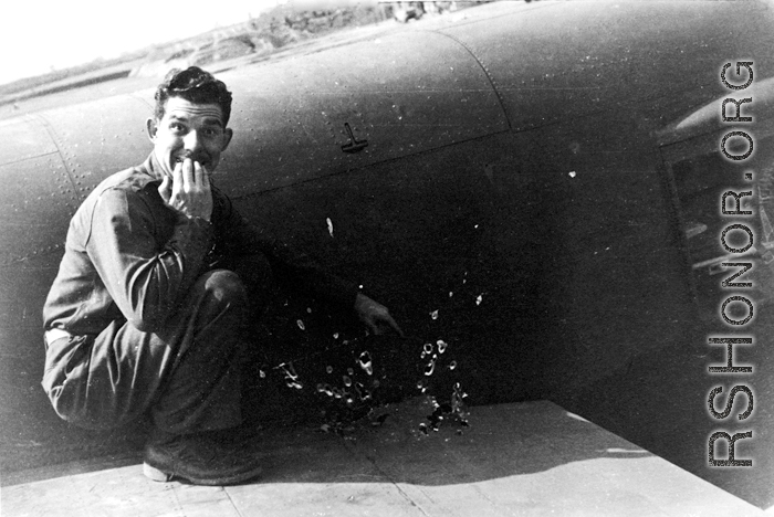 After returning to Liuzhou (Liuchow), China, Capt. Robert C. Pettingell, 491st Bomb Squadron Flight Leader, poses next to some of the damage received by the B-25J he was flying on a mission against White Cloud airfield near Canton in the spring of 1944.  (Info courtesy Tony Strotman)