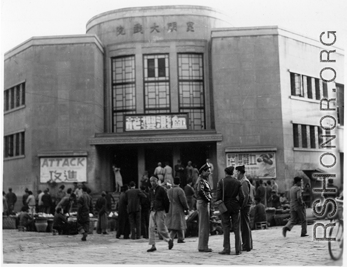 American GIs stand in front of market and and movie theater in Kunming, Yunnan province, China. During WWII.