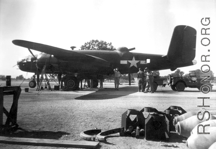 A B-25 under maintenance in the CBI during WWII. Notice the canvas cover over the turret on the fuselage.  From the collection of combat photographer Eugene T. Wozniak, 491st Bomb Squadron.
