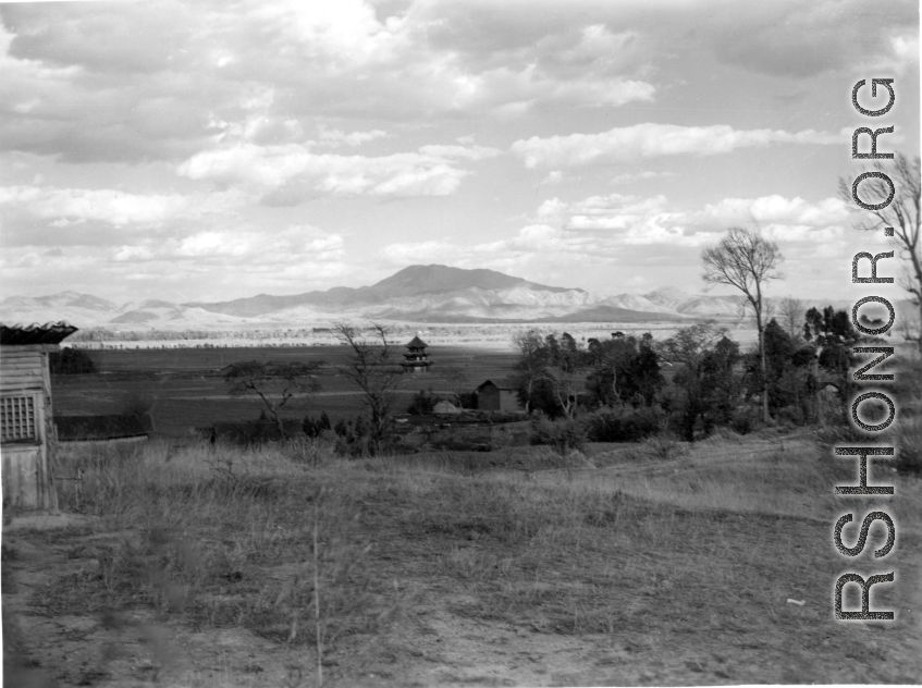 Beautiful rural scenery in Yunnan province, China, near Yangkai, during WWII, taken by Eugene Wozniak, showing an attractive tower in the plain.