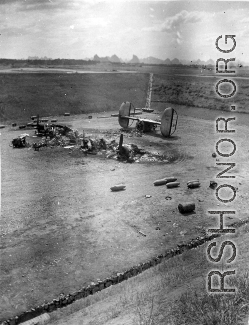 "What One Small Fragmentation Bomb Could Do--This B-24 was hit with one small fragmentation bomb during one of the nightly air raids at Luichow [Liuzhou], China.This particular plane just happened to be a new B-24 that had never flown a mission. As bad as it looks it was not a total loss since the engines were removed, inspected and run-outs done on the crankshafts to be sure they were not damaged. All the engines were used to replace blown engines on the B-24's that were flying gas into China from India. T