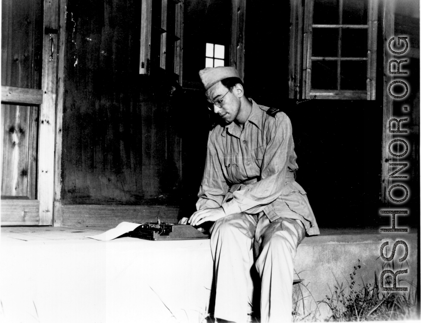 A GI typing on a small typewriter in the China during WWII.