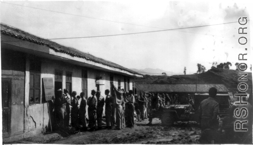 GIs line up at base supply at a base in China during WWII.