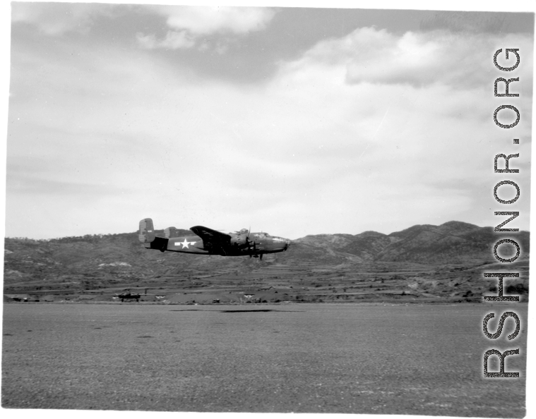 A B-25 Mitchell bomber races by close to the ground, at Yangkai (Yangjie) air strip in Yunnan province, China.