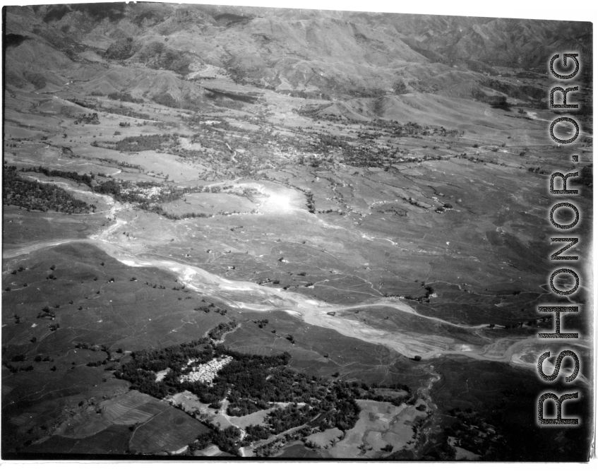Smoke rises on the ground after an attack by American B-25s in either SW China, Indochina, or the Burma area.  This might be fairly close to Tengchong in China.
