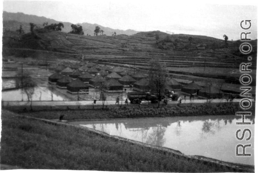 Tent city of flooded living quarters at Liangshan. Stream next to the site has overflowed in this image. During WWII.
