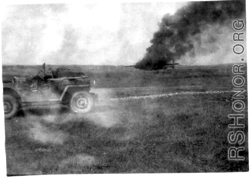 An American aircraft burns at a base in China during WWII.