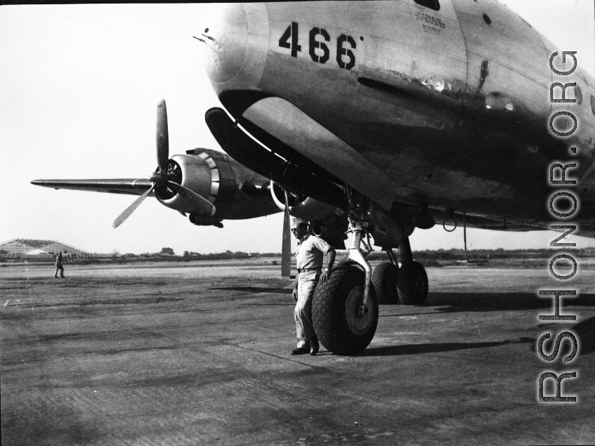 GI stands before a C-54 transport plane in the CBI.    From the collection of David Firman, 61st Air Service Group.
